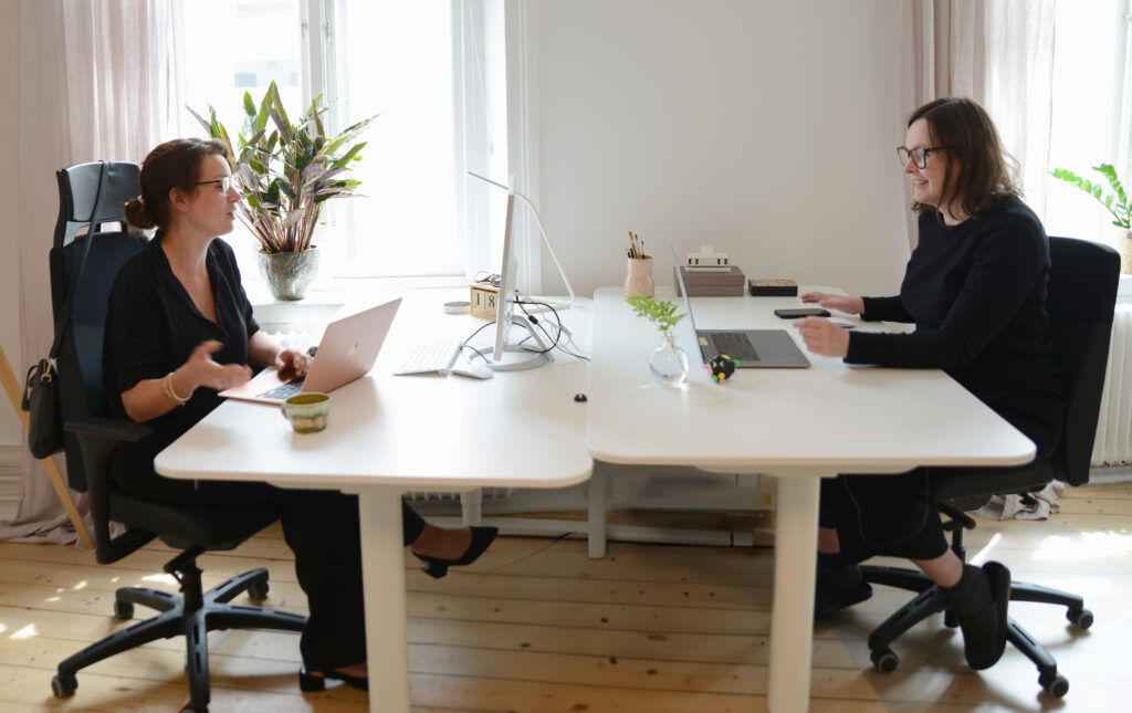 Two co-workers talking a laughing