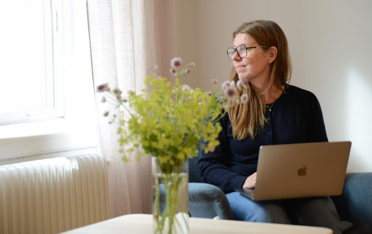 Woman sits with a laptop